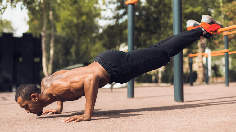 person outdoors performing push-up