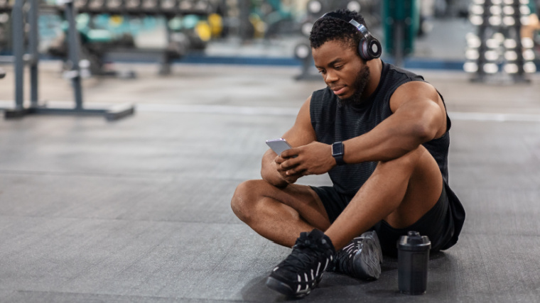 muscular person in gym typing on phone