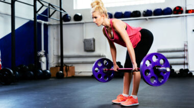 person in gym doing deadlift exercise