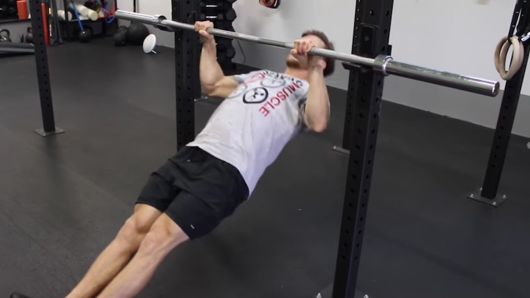 person in gym doing bodyweight row