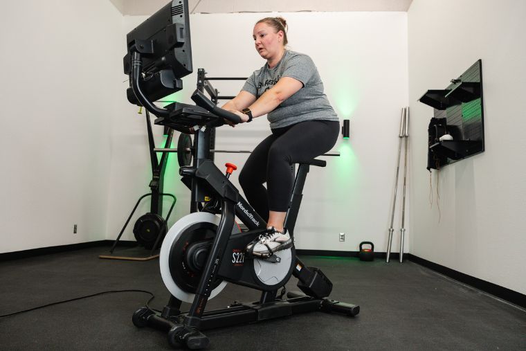 A female athlete riding the NordicTrack S22i Studio Bike