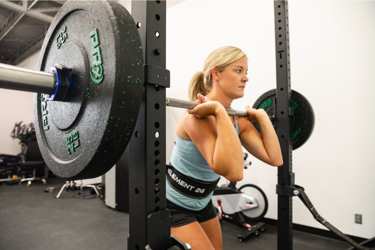 An athlete unracking the REP Double Black Diamond barbell from a squat rack