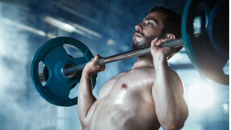 muscular man pressing barbell overhead